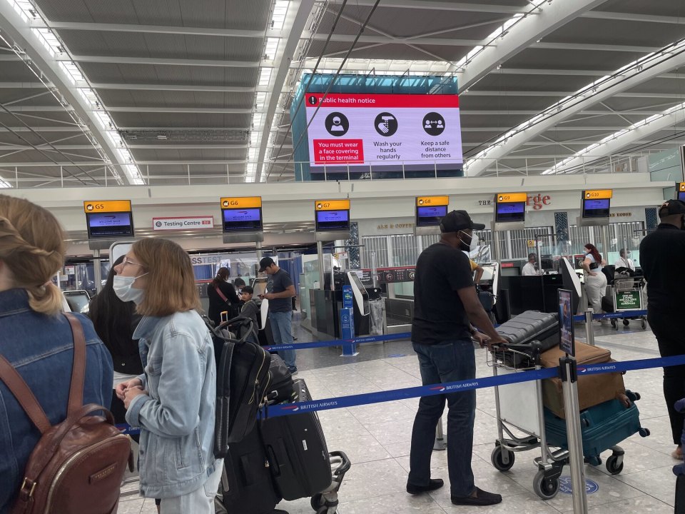 Passengers with suitcases at airport check-in desks