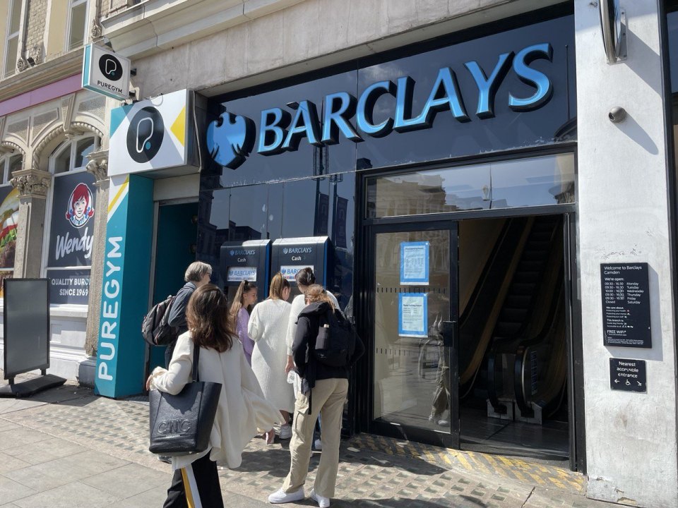 Passers-by outside a bank branch on a London street