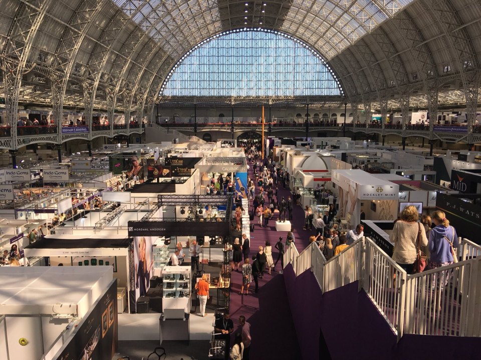 Visitors at a British business exhibition beneath a glass roof