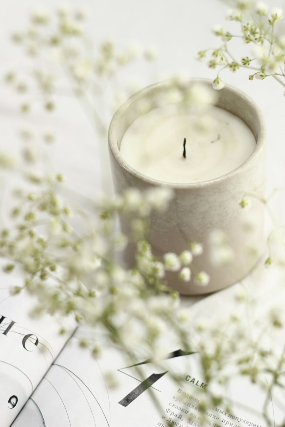 A candle and white flowers