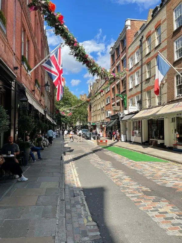 A London shopping street with flags and shoppers