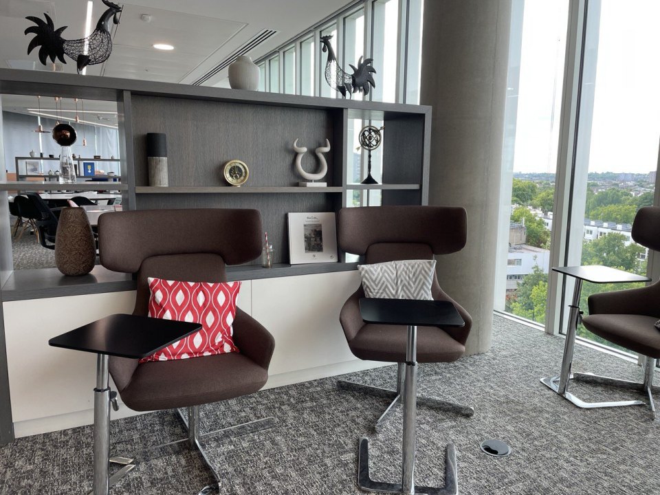 An office area with chairs and shelves