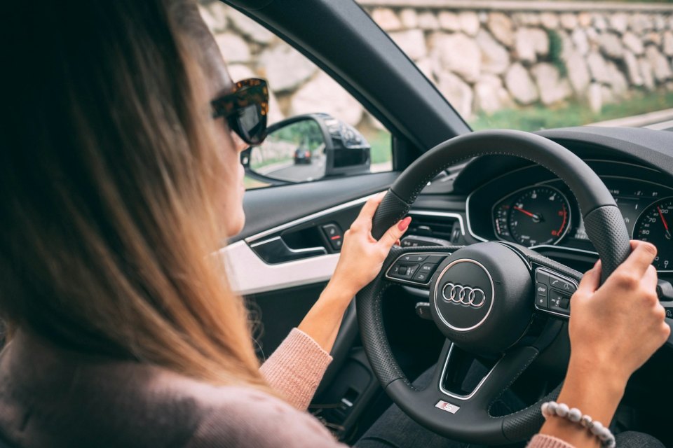 A driver at the wheel of a moving car