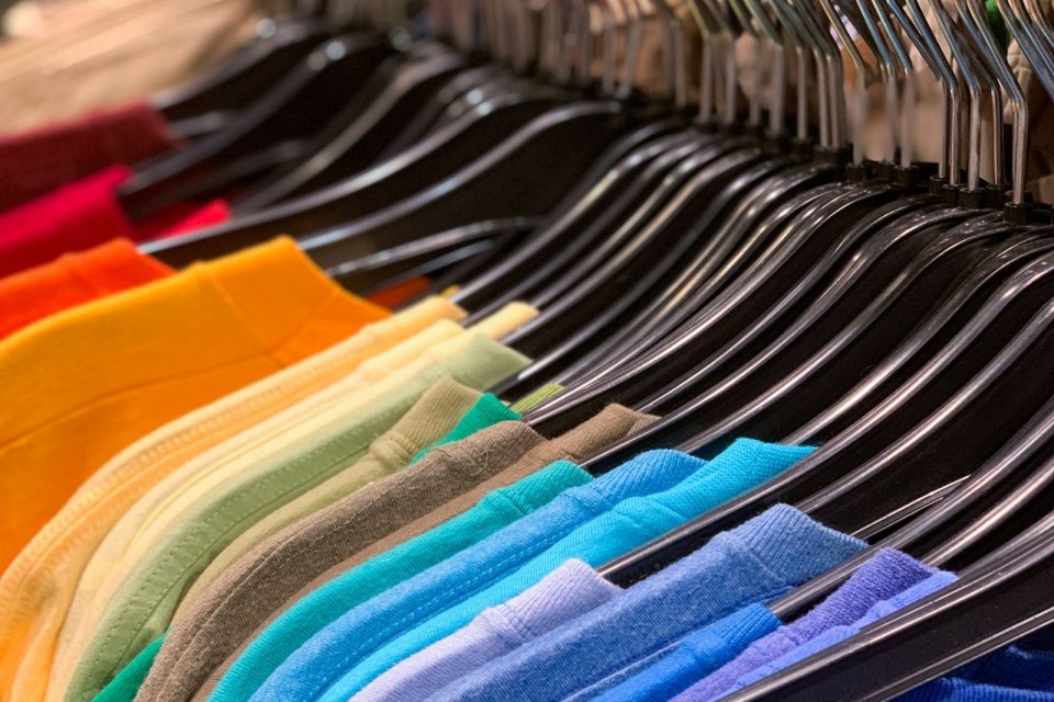 Colourful clothes hanging on a rack
