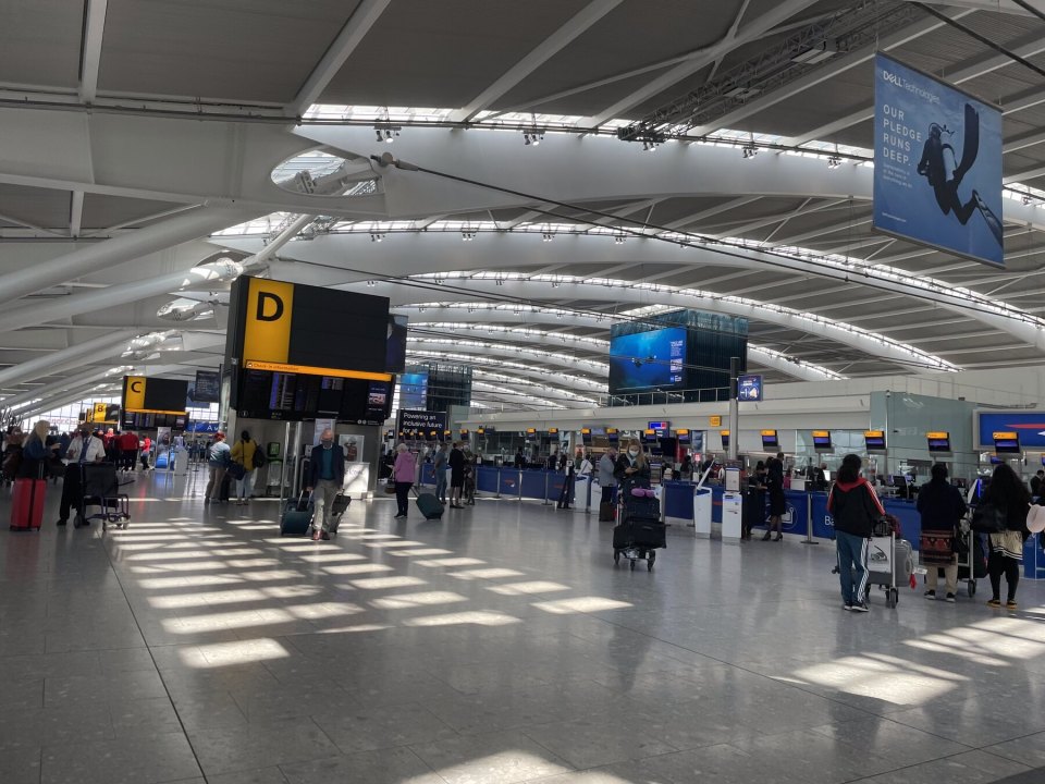 Heathrow departures hall with travellers and luggage