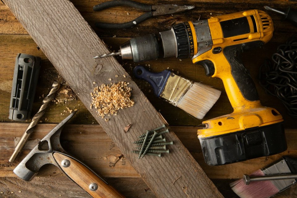A drill and tools on a workbench