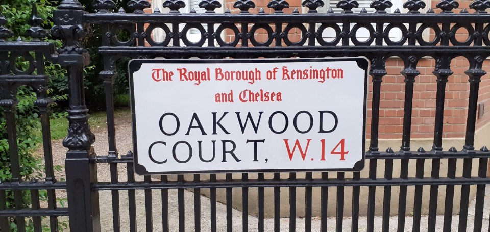 A London borough street sign for Kensington and Chelsea on an iron railing
