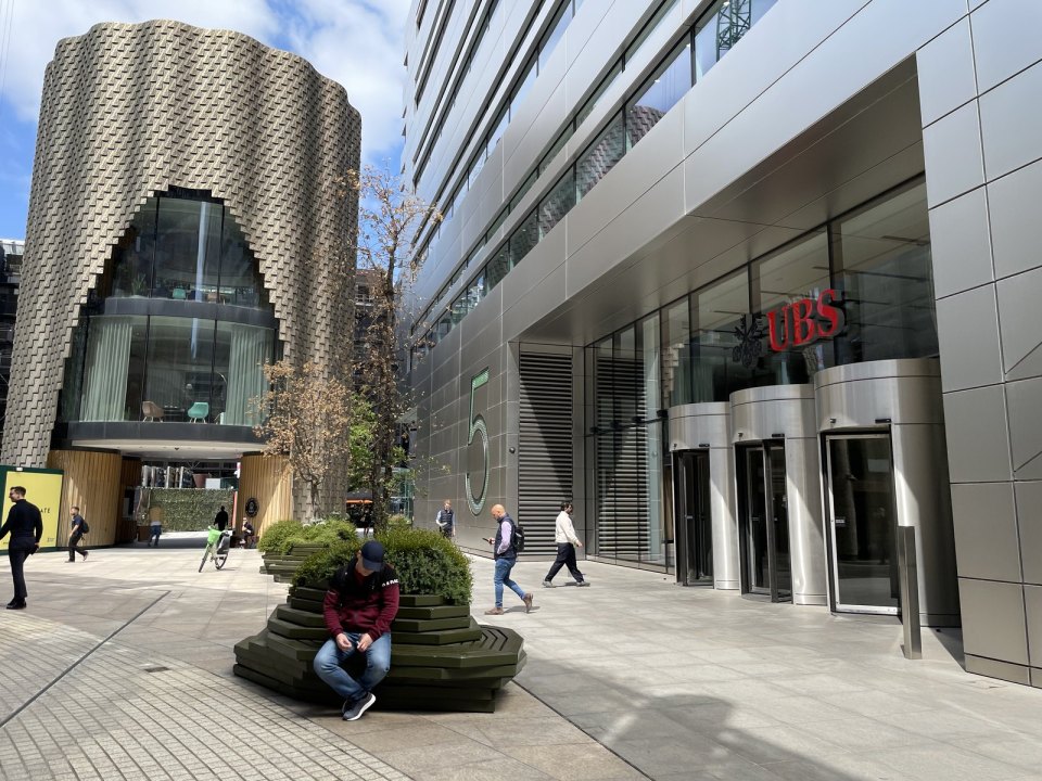 A City of London business district: modern offices and a man looking at his phone