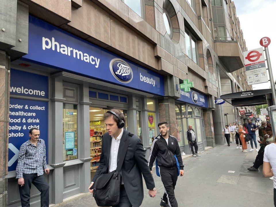 Аптека Boots на лондонской улице у станции Moorgate, прохожие на тротуаре