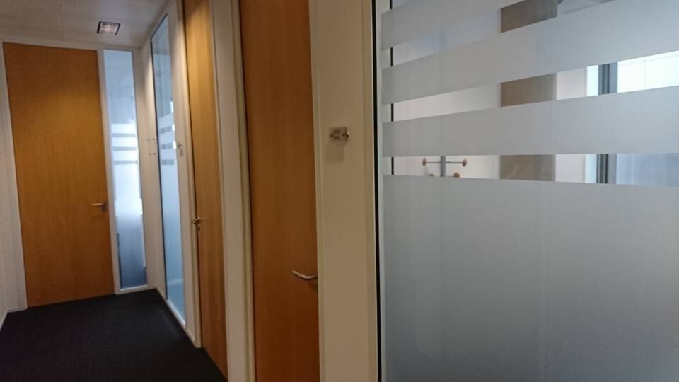 Corridor of a London office building with closed office doors