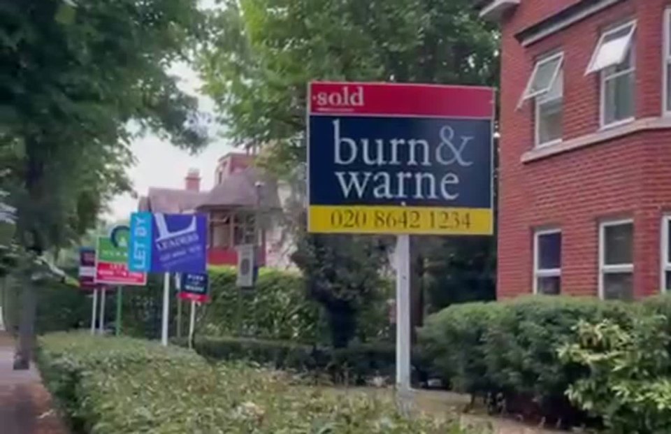 A residential street with Let By and Sold estate agent boards