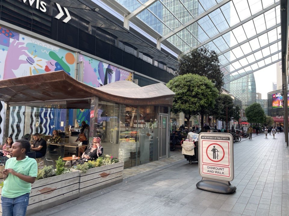 Street cafe in a shopping arcade with customers at tables