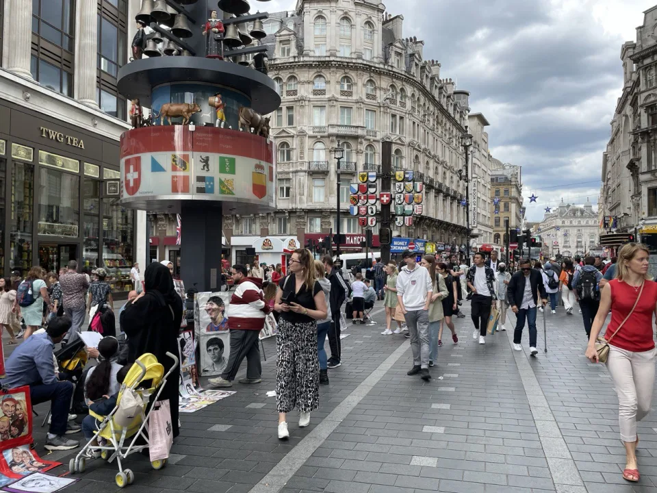 A London shopping street with small shops and passers-by