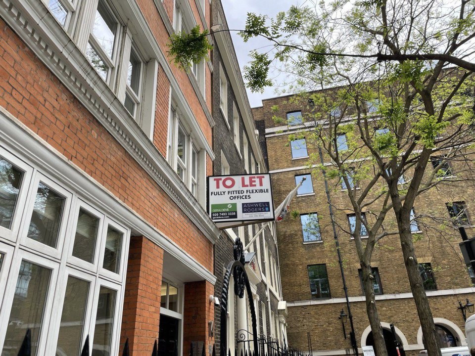 A London street: a brick building with a TO LET sign, trees and parked cars