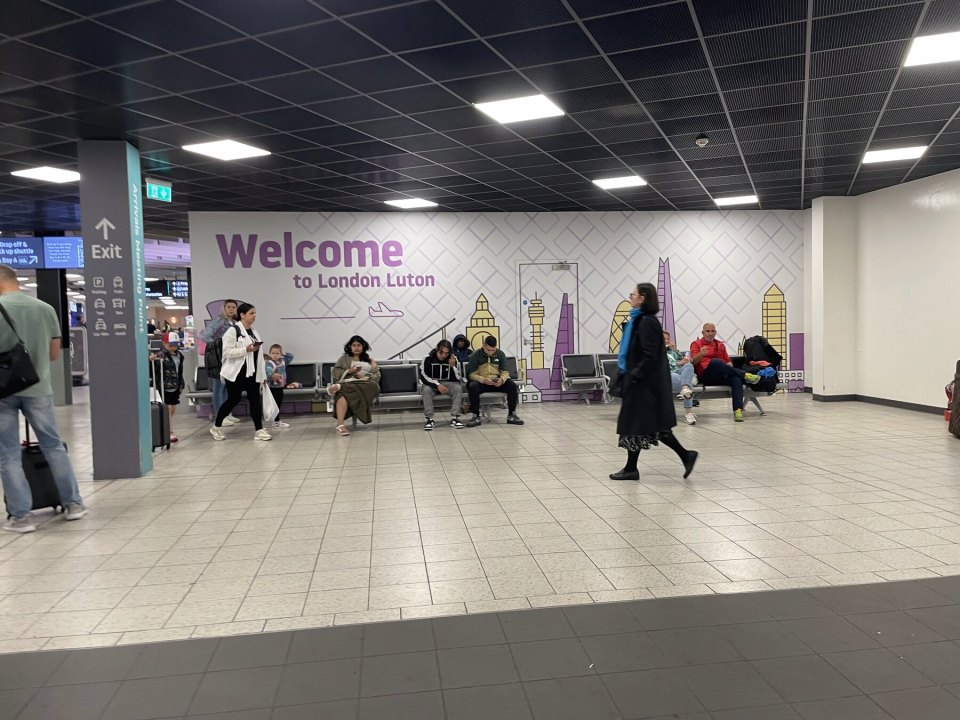 Arrivals hall at Luton airport with a Welcome to London Luton sign