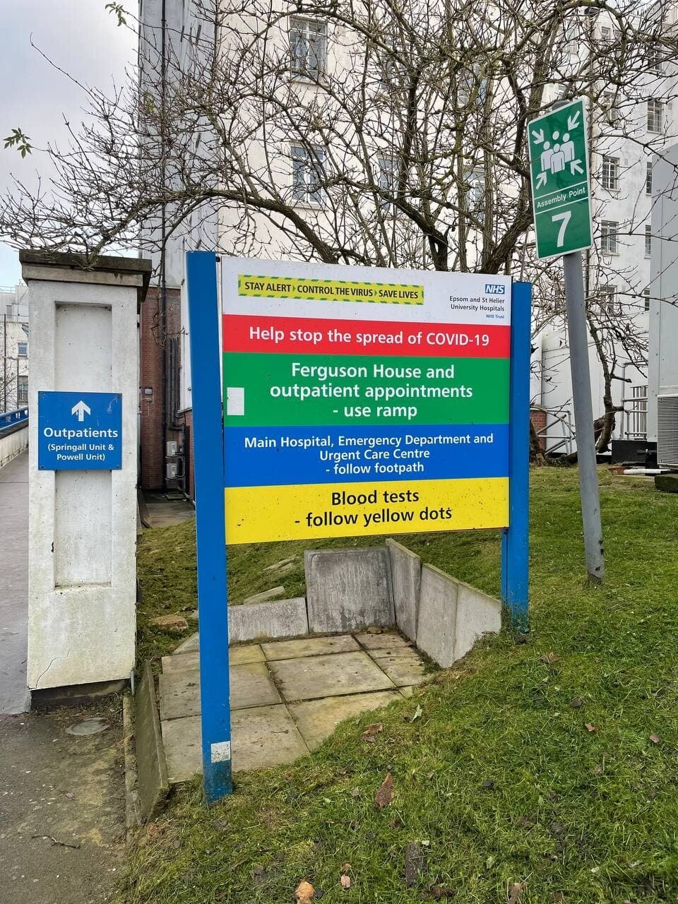 NHS hospital signage pointing to outpatients and blood tests