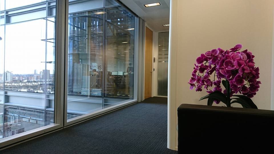 Empty office corridor with a glass wall and a city view