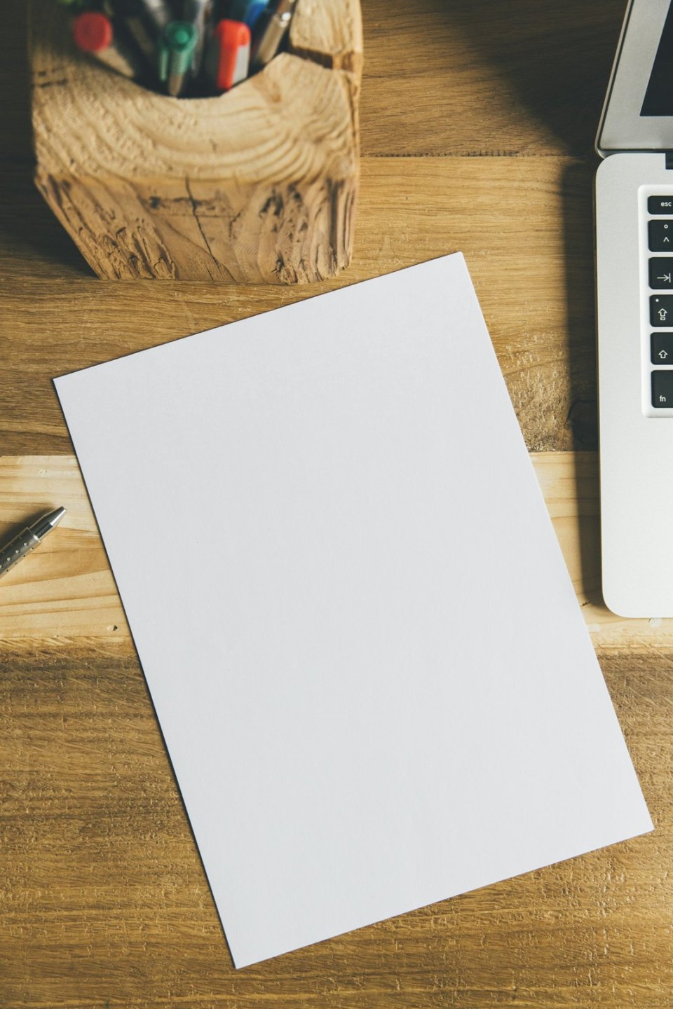 A blank sheet and pen on a desk