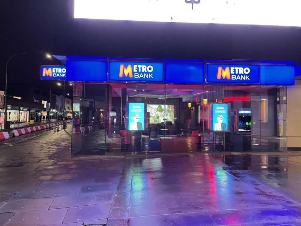 An illuminated bank branch in Britain at night