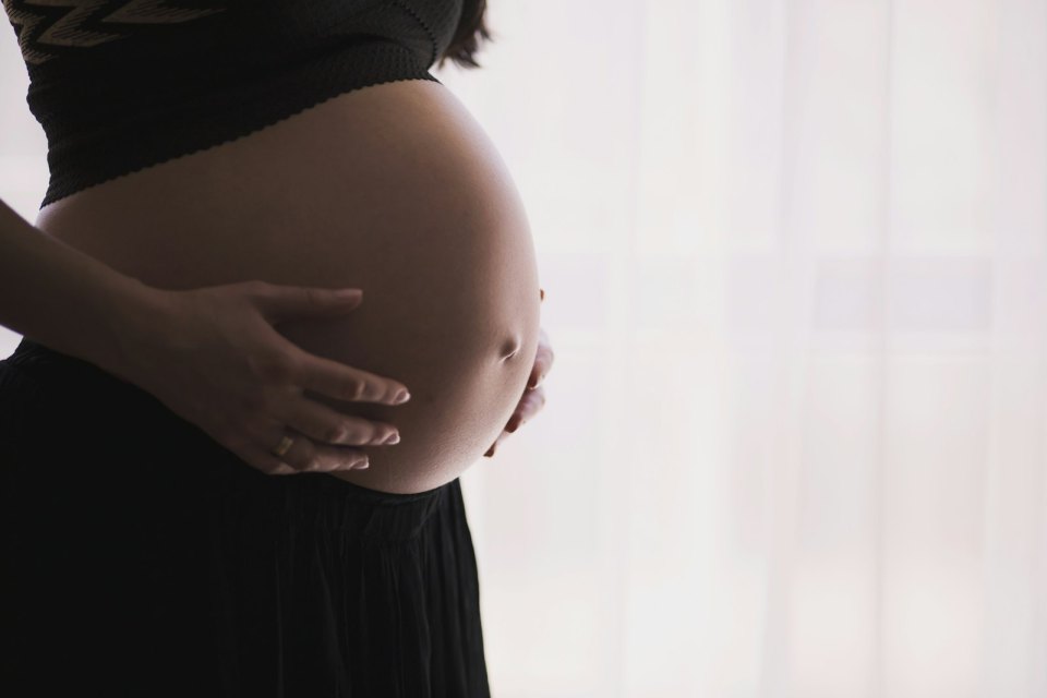 A pregnant woman by a window