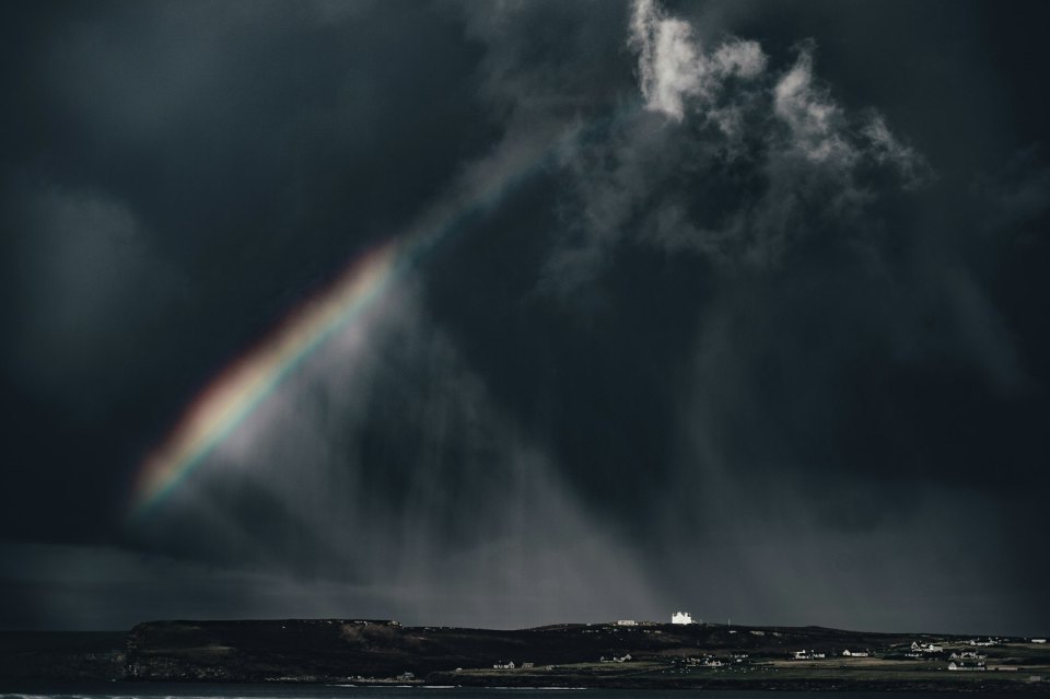 Dark storm sky with rain over the coast