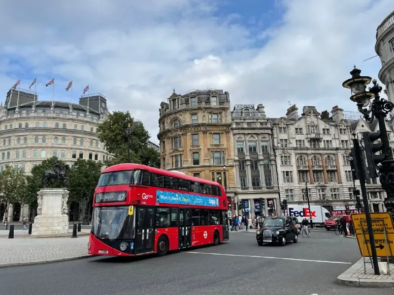 A red double-decker bus in Trafalgar Square, London