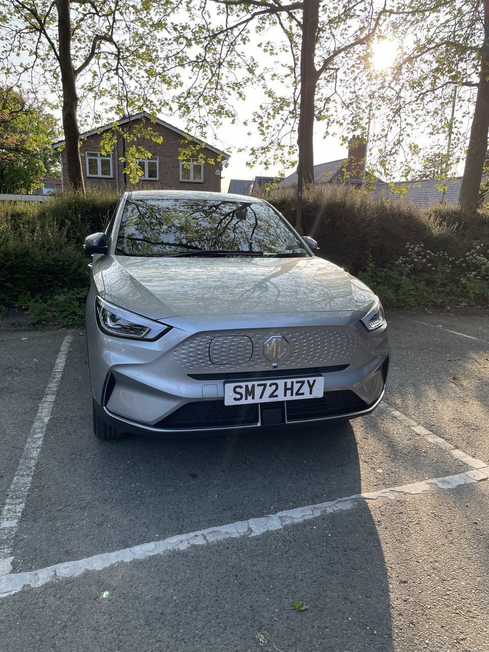 A car with a UK number plate parked at the kerb