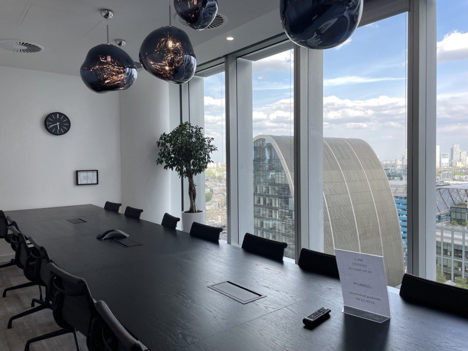 An empty meeting room in a UK office, table and chairs with nobody there