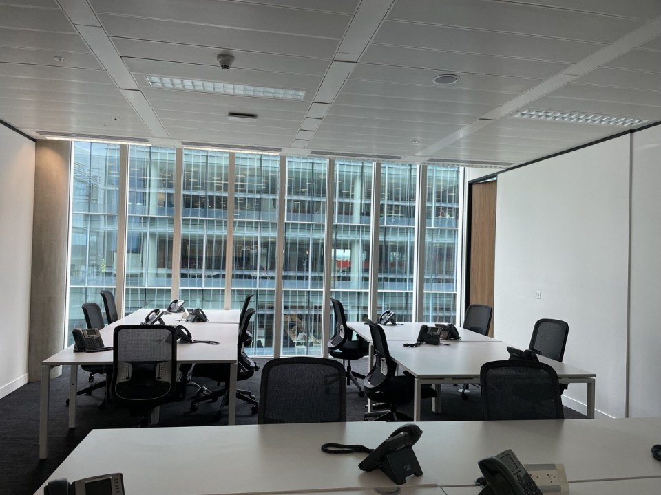 Office workstations with desks and telephones