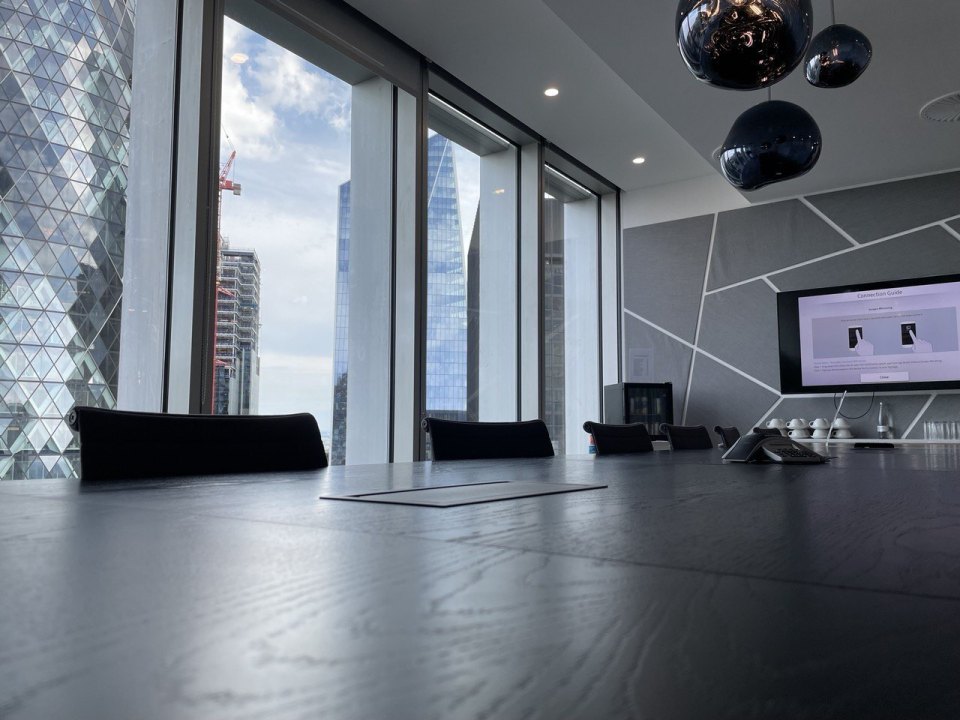 Empty meeting room with a long table and chairs in a London office