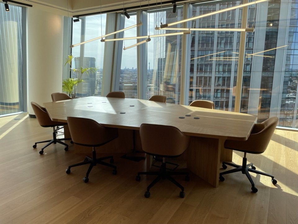 A meeting room with a table and chairs in an office