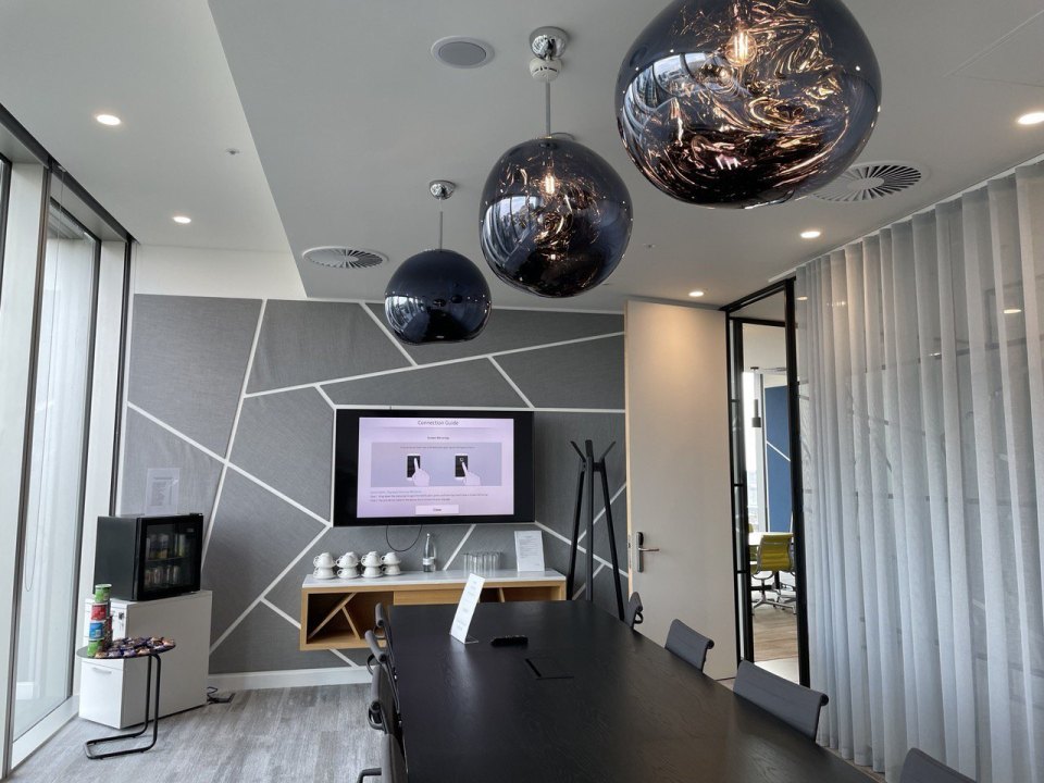 A meeting room with a screen in a London office
