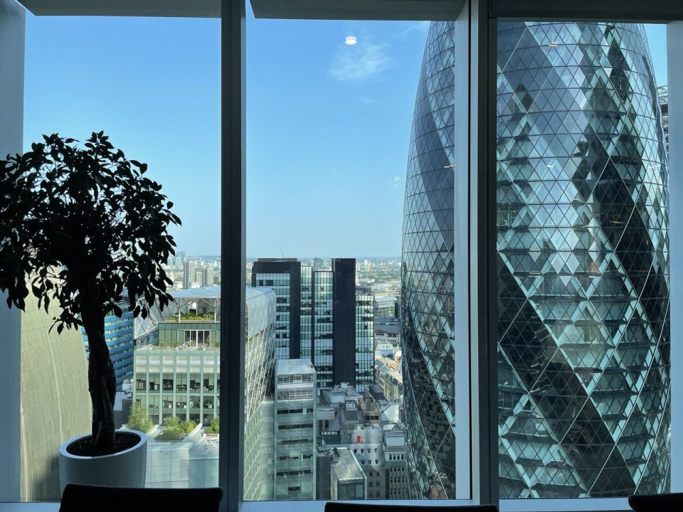 Window of a London office with a view over the business district