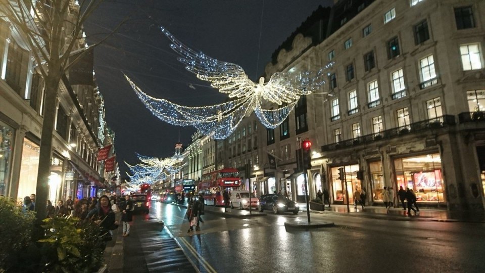 Wet London street beneath evening lights