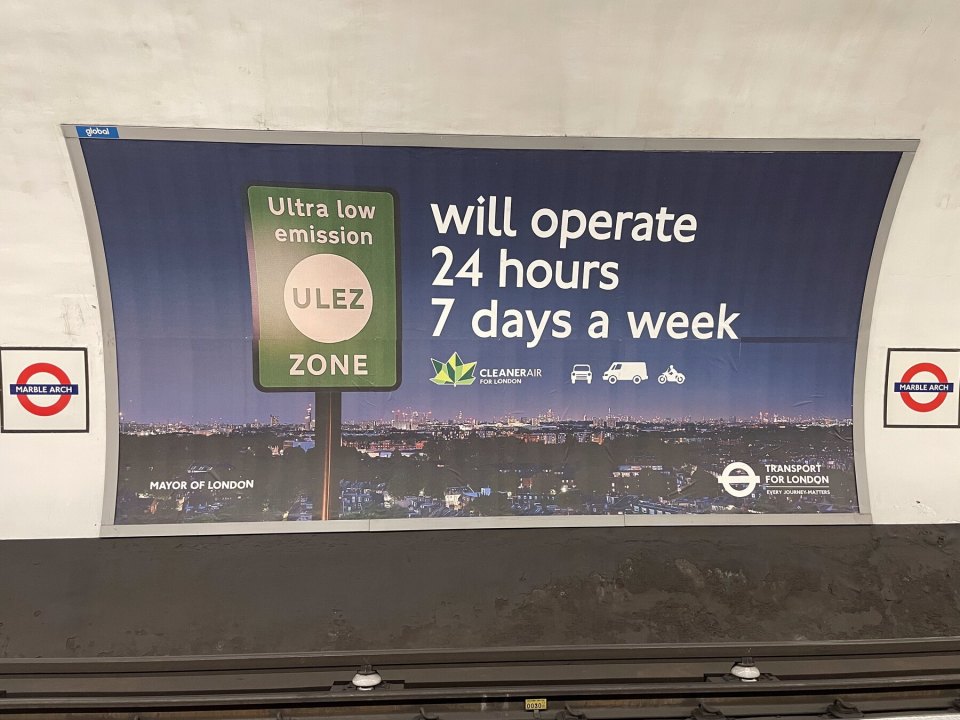 Transport for London poster about ULEZ hours at a London Underground station