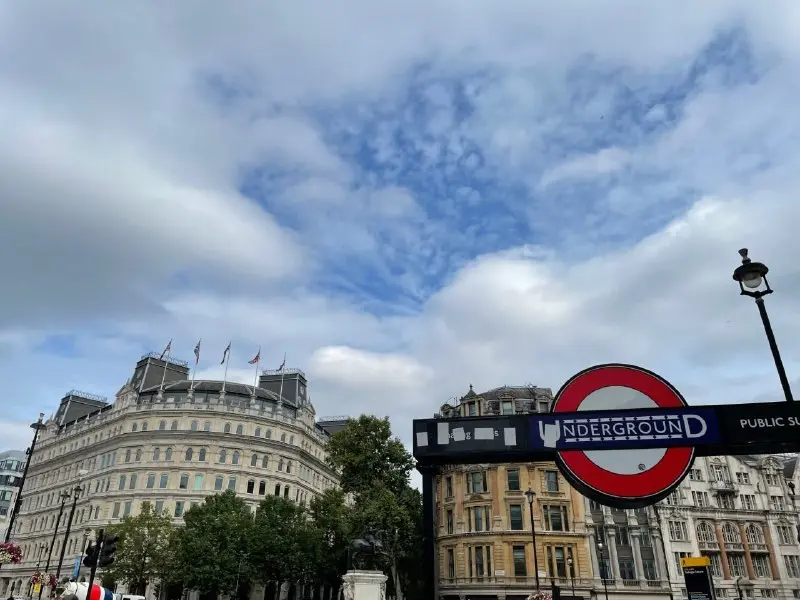 London Underground roundel at a station entrance against the sky