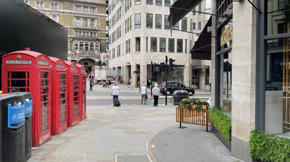 Red telephone boxes on a street in central London