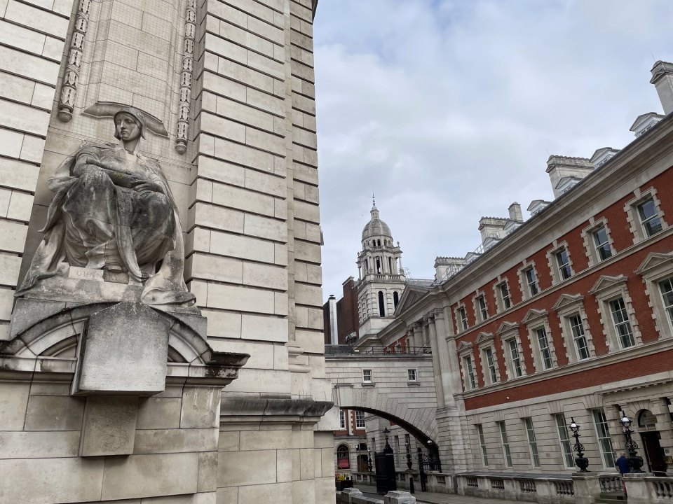 The facade of a government building in Whitehall with a stone sculpture